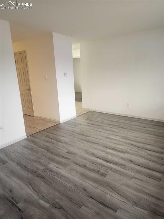 Image 8 of 13: Spare room featuring wood finished floors and baseboards