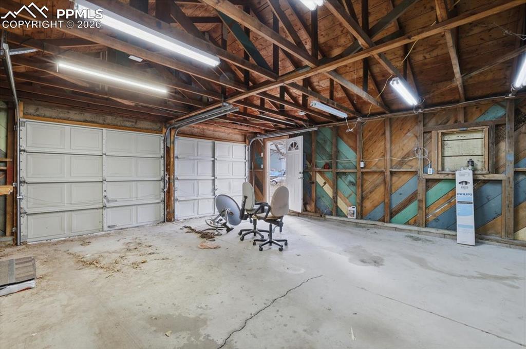 Image 22 of 24: Garage with wooden walls