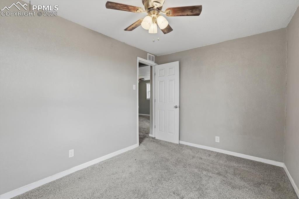Image 7 of 24: Carpeted spare room featuring baseboards and a ceiling fan