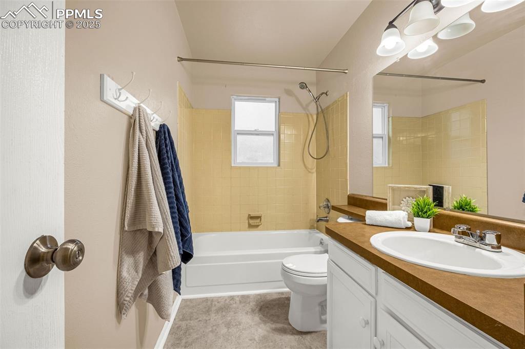 Image 21 of 38: Bathroom with shower combination, vanity, and toilet