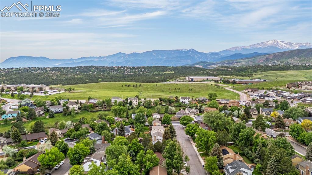 Image 35 of 38: Aerial perspective of suburban area with a mountainous background