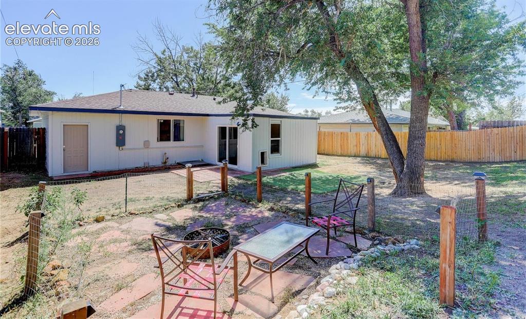 Image 17 of 17: Expansive backyard with a full privacy fence and mature trees