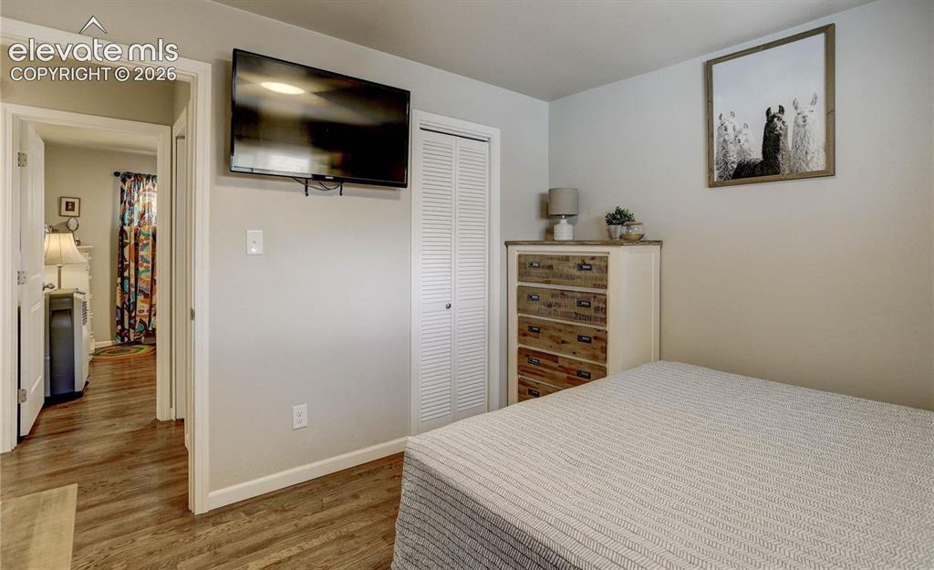 Image 9 of 17: Wood-finish flooring throughout, neutral wall tones, white trim, and a bi-f