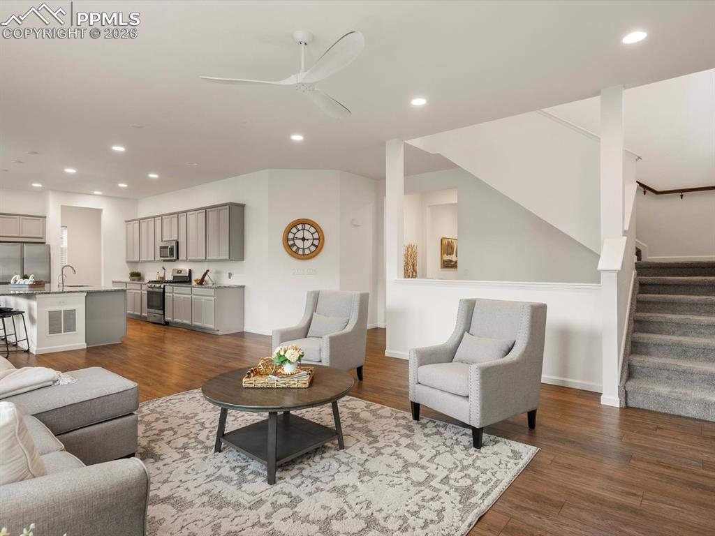 Image 11 of 45: Open concept living area with hardwood flooring and recessed lighting