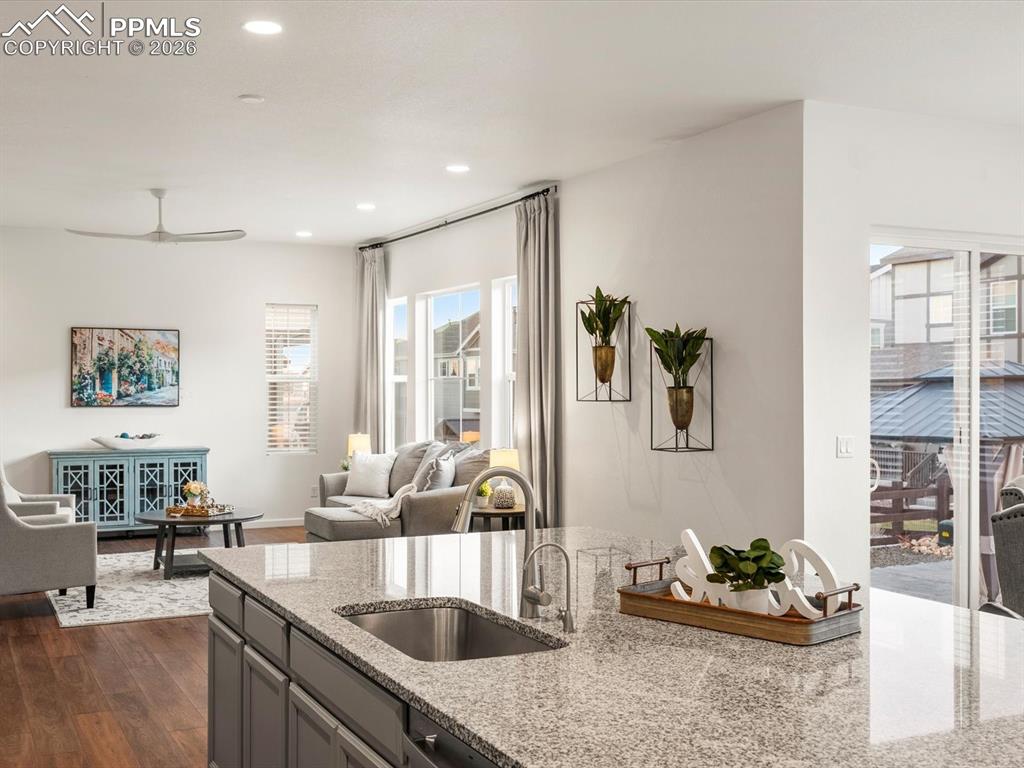 Image 14 of 45: The kitchen features a granite countertop with an integrated sink and a mod