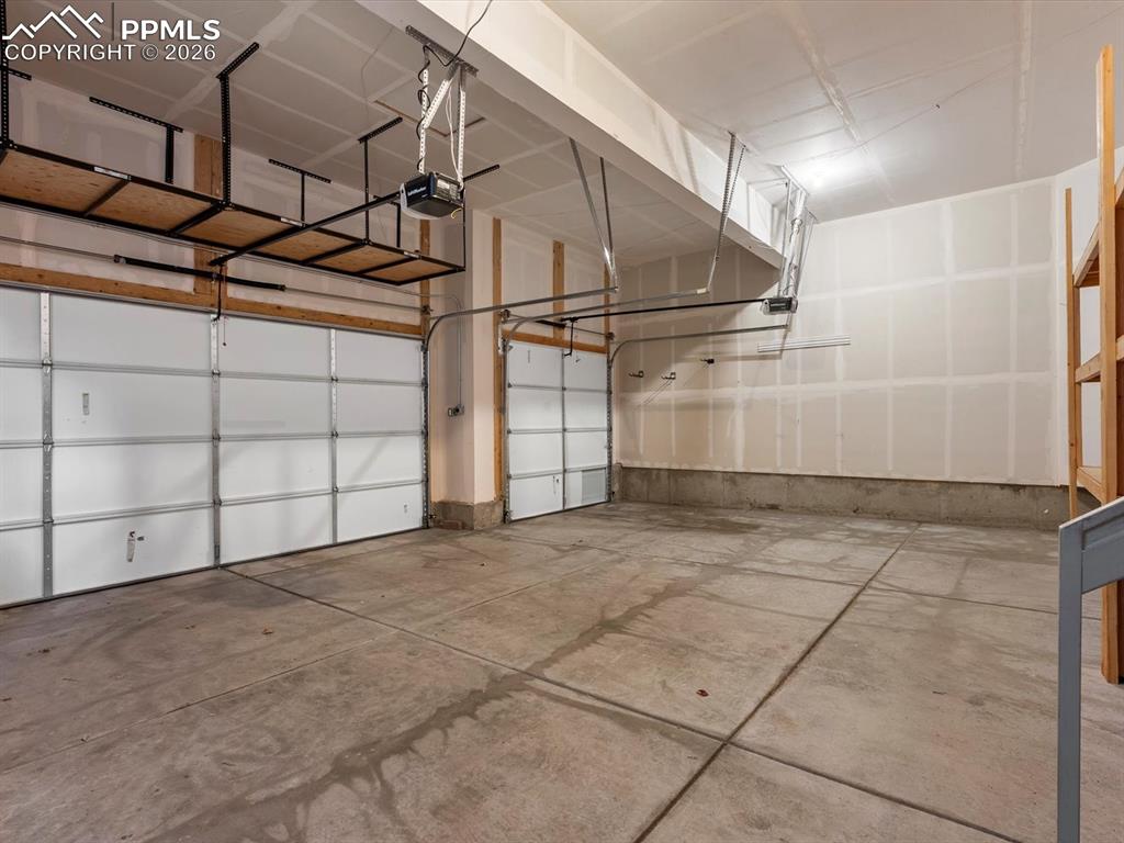 Image 22 of 45: The property includes a spacious two-car garage with concrete flooring