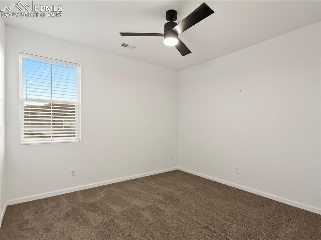 Image 32 of 45: This room features a window with blinds, carpeted flooring, and a ceiling f