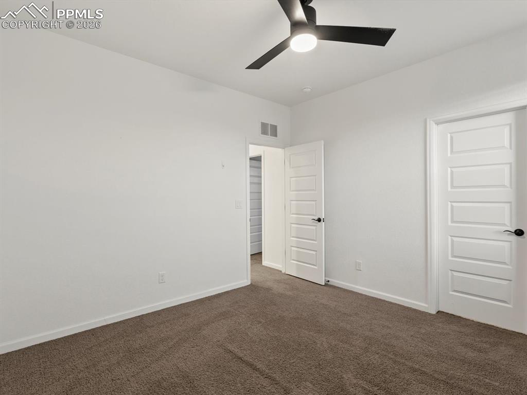 Image 33 of 45: This room features neutral-toned carpet, white walls, and a contemporary bl