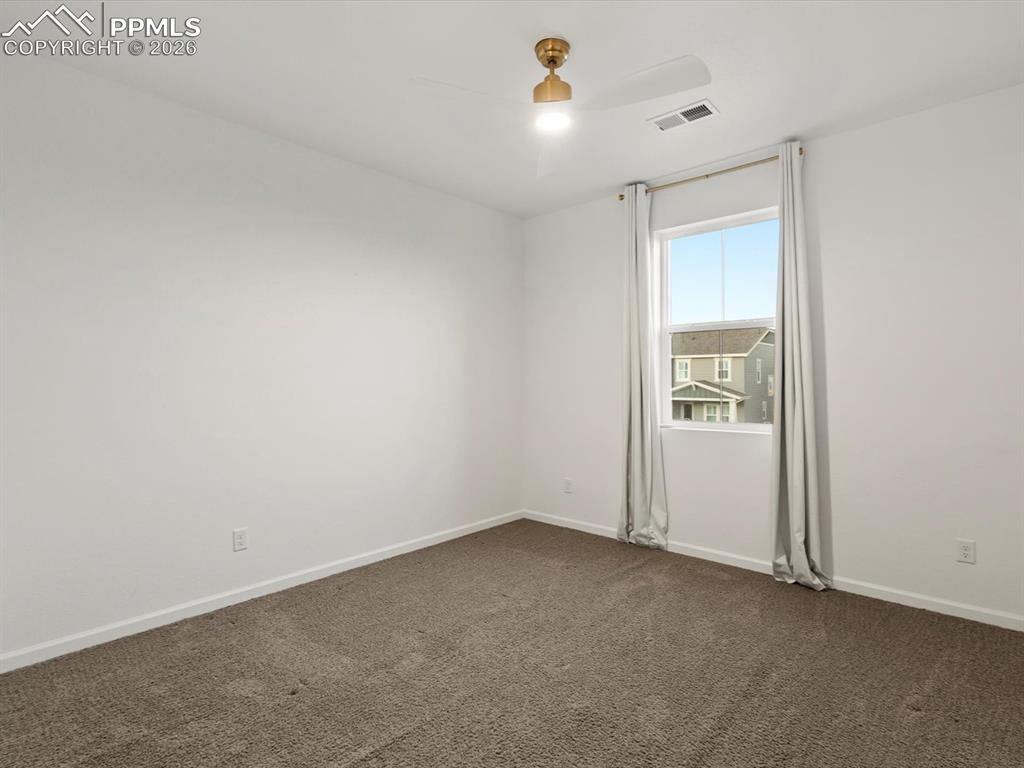 Image 34 of 45: This room offers a bright atmosphere with white walls and a large window, f