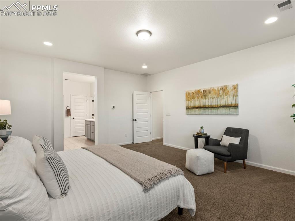 Image 37 of 45: This room features plush brown carpeting, a light-colored accent wall, and 