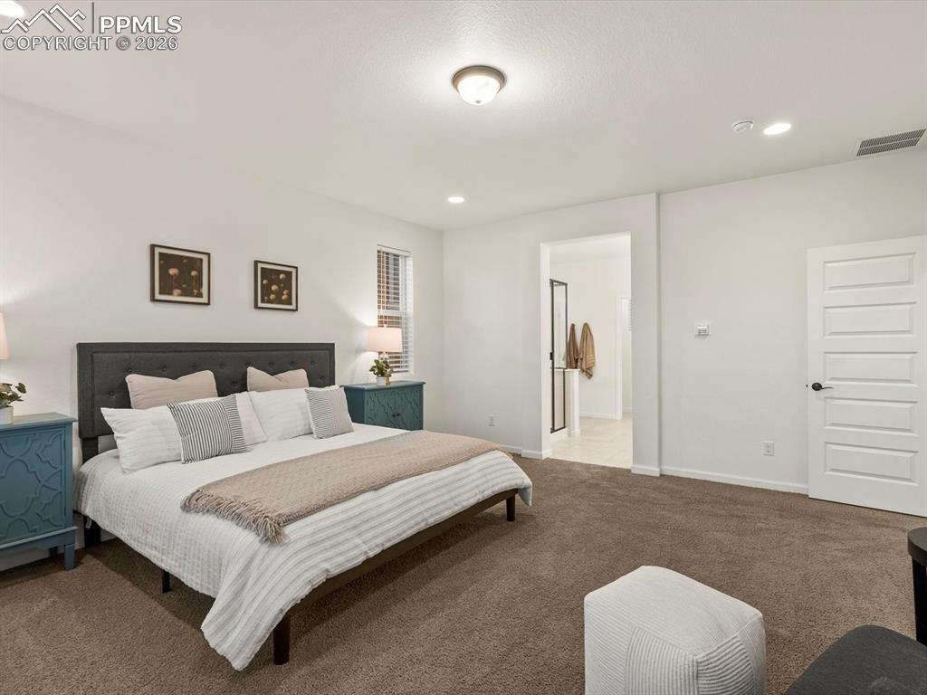 Image 38 of 45: This room features soft brown carpeting, white walls, and recessed lighting