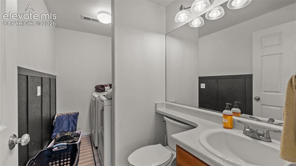 Image 11 of 34: Bathroom with a single vanity, integrated sink, and overhead lighting
