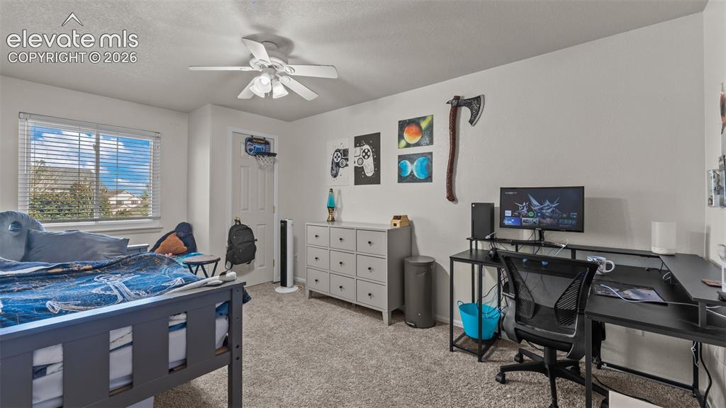 Image 20 of 34: Carpeted flooring, white walls, window with horizontal blinds, built-in cei
