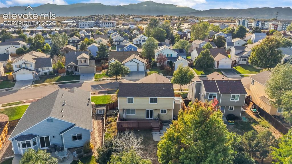 Image 30 of 34: Residential neighborhood with a mountain backdrop