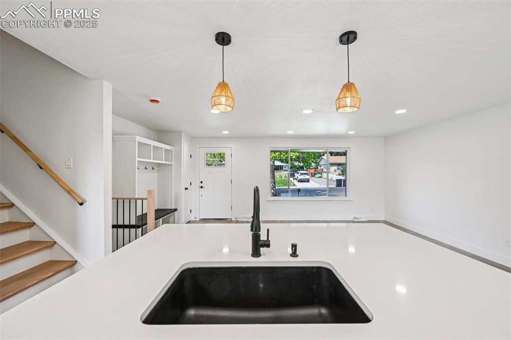 Image 14 of 49: Kitchen with recessed lighting, pendant lighting, and light countertops