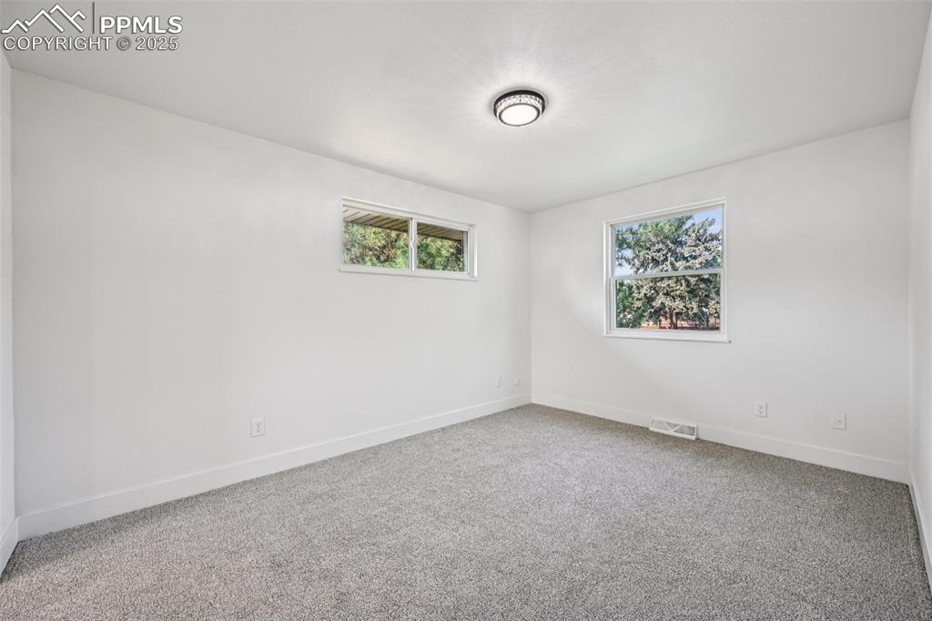 Image 18 of 49: Empty room featuring carpet floors