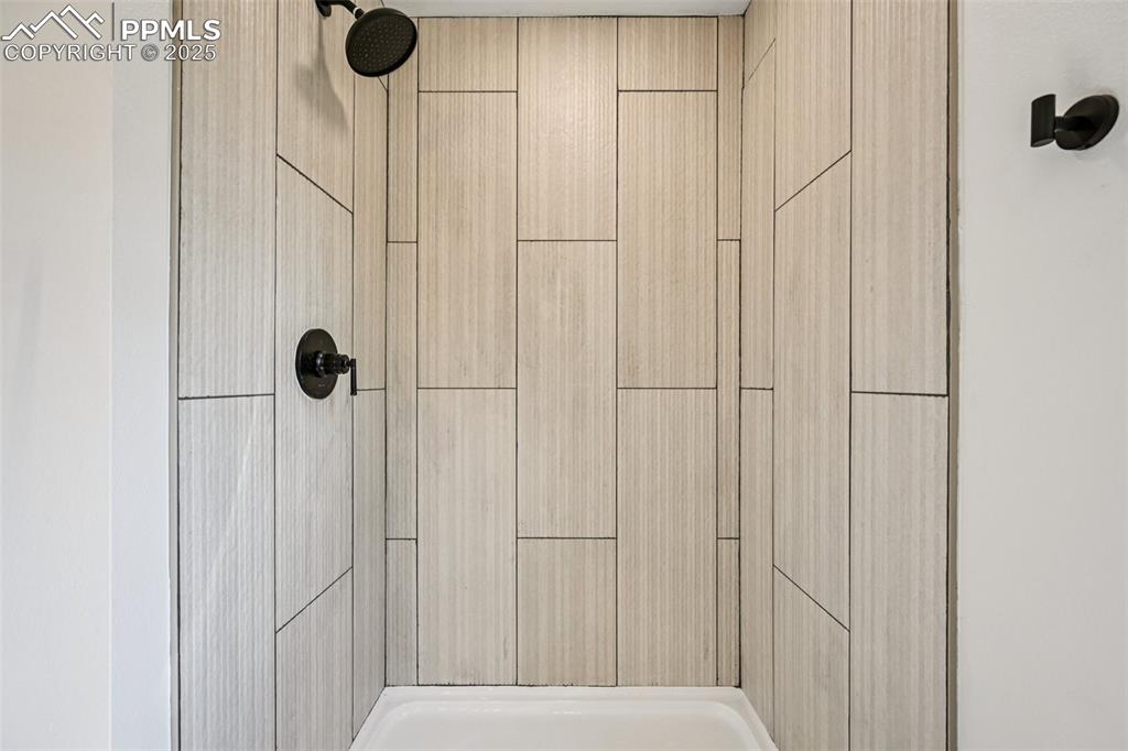 Image 20 of 49: Bathroom view of a tile shower