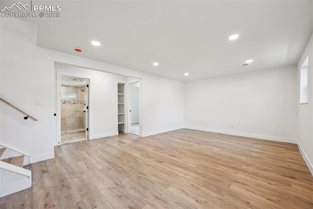 Image 29 of 49: Unfurnished living room with light wood-style flooring and recessed lightin
