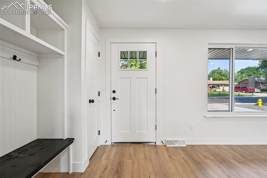 Image 3 of 49: Mudroom with light wood finished floors and baseboards