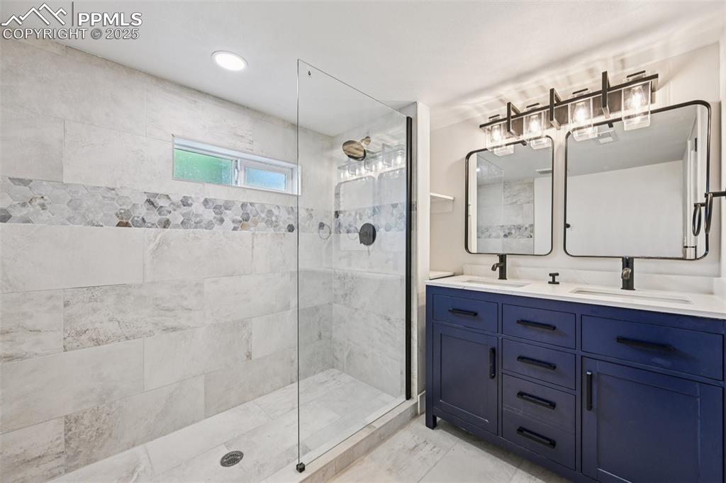 Image 33 of 49: Full bath with walk in shower, double vanity, and recessed lighting