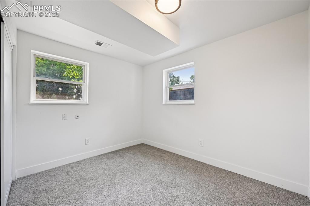 Image 36 of 49: Carpeted spare room with baseboards