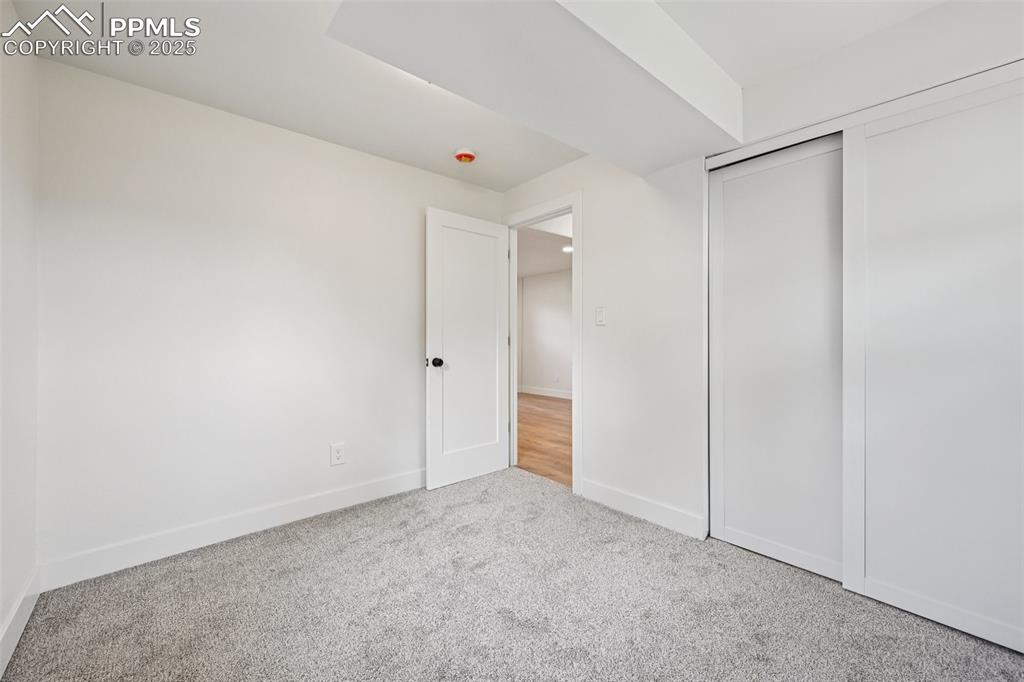 Image 37 of 49: Unfurnished bedroom with carpet and a closet