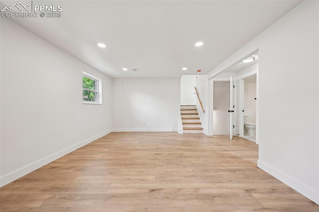 Image 38 of 49: Spare room with recessed lighting, stairway, and light wood-style floors