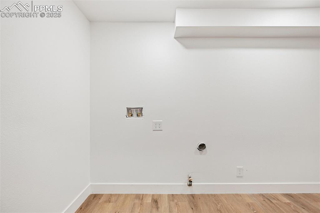 Image 41 of 49: Laundry room featuring light wood finished floors, gas dryer hookup, and wa