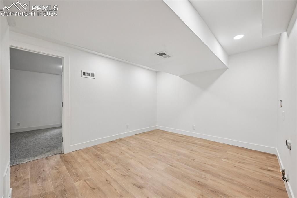 Image 42 of 49: Spare room with light wood-style flooring and recessed lighting