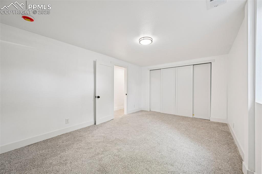 Image 43 of 49: Unfurnished bedroom featuring a closet and light carpet