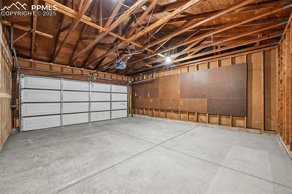 Image 44 of 49: Garage featuring a garage door opener
