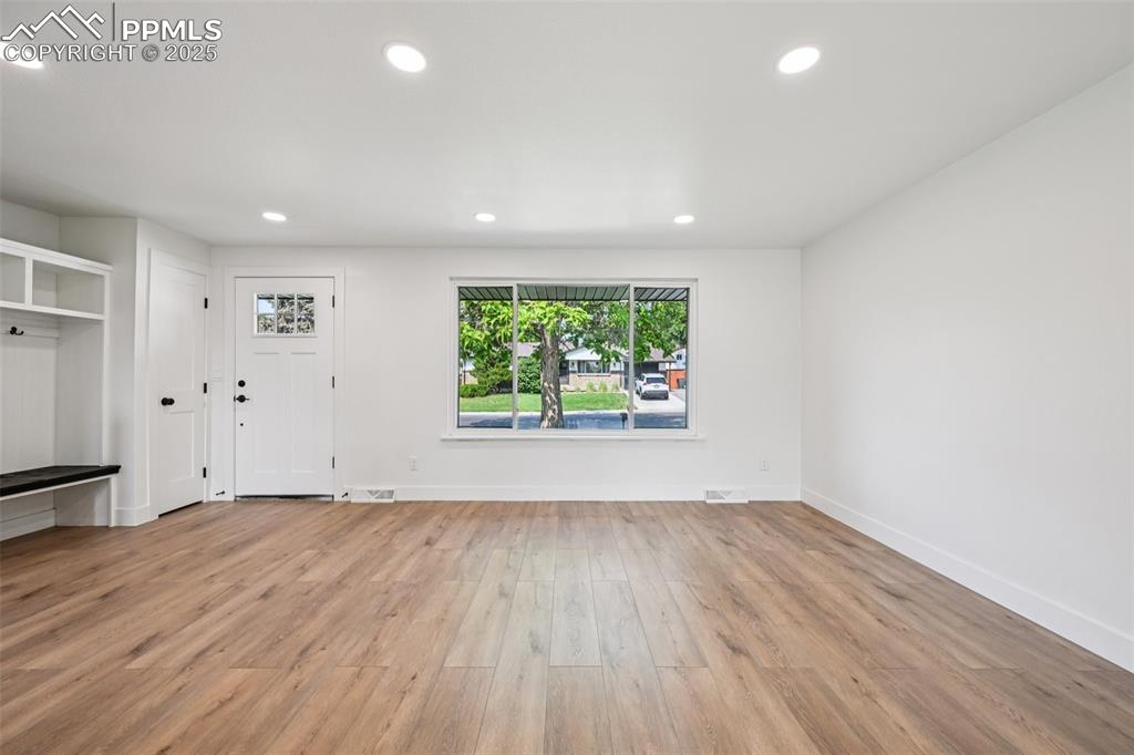 Image 6 of 49: Unfurnished living room featuring recessed lighting and light wood-style fl