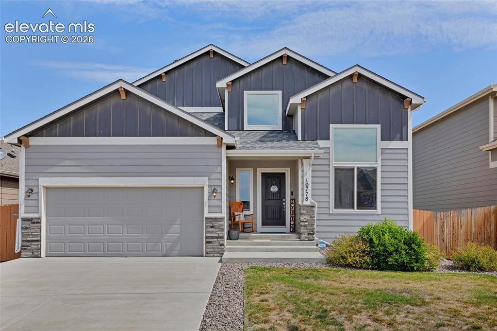 Image 1 of 38: Two-story residence featuring light gray siding, dark gray board-and-batten