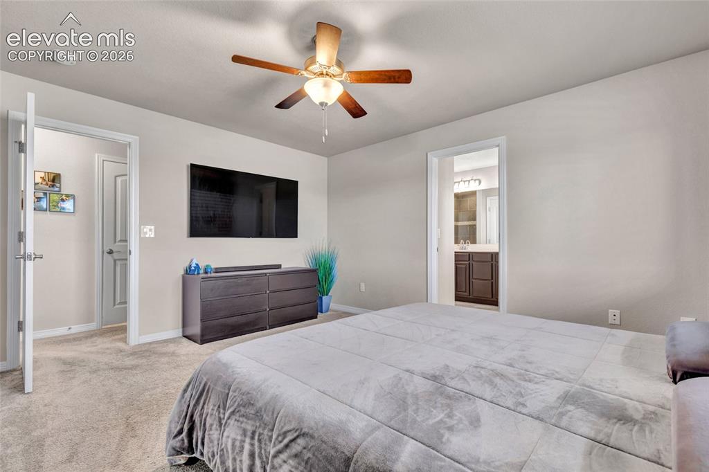 Image 16 of 38: Carpeted room with a ceiling fan