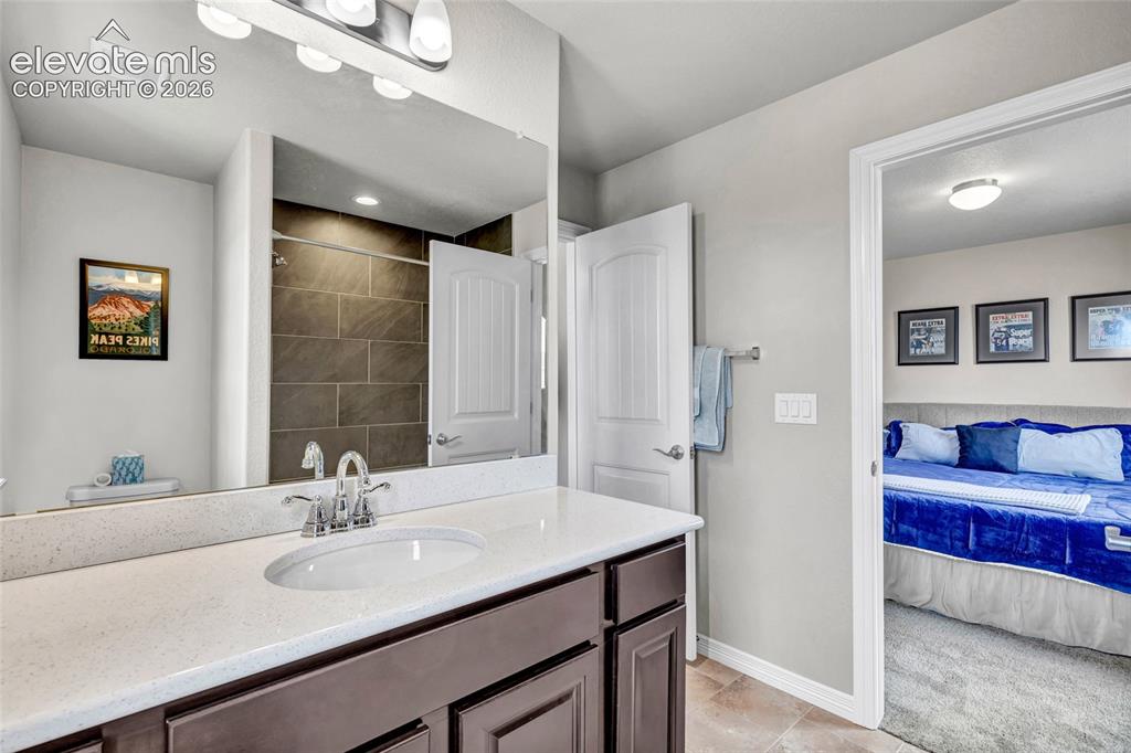 Image 27 of 38: Bathroom vanity featuring a light-colored countertop with an integrated sin