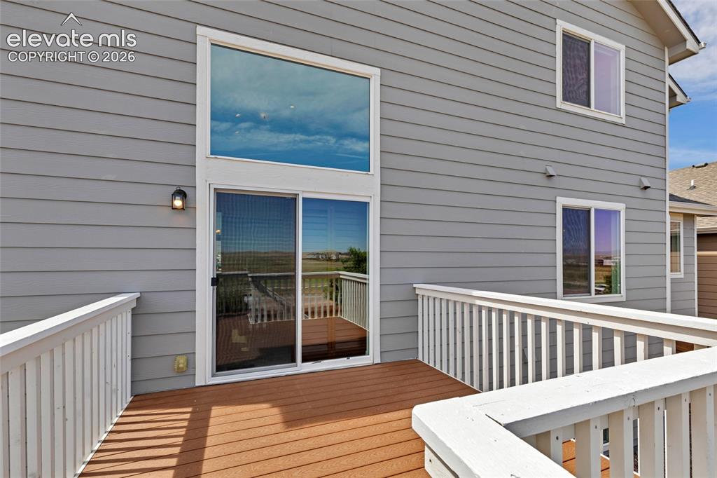 Image 33 of 38: Deck with wood-finish flooring and white railings