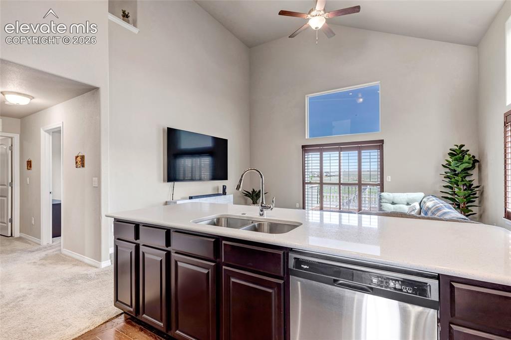 Image 7 of 38: Kitchen island with a double basin stainless steel sink and a stainless ste