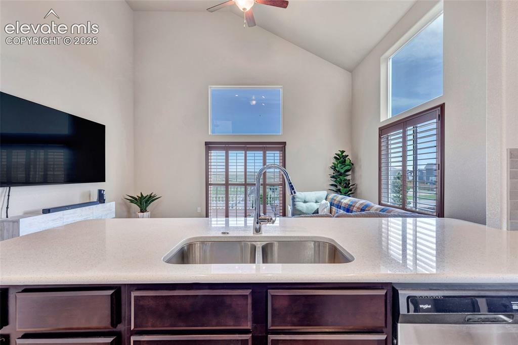 Image 8 of 38: Kitchen island featuring a double basin stainless steel sink and a goosenec