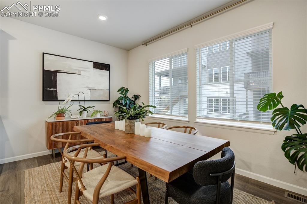 Image 14 of 50: Dining area with wood-style floors and recessed lighting