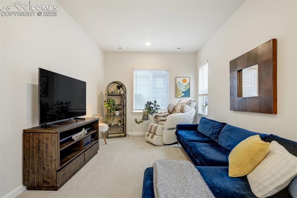 Image 16 of 50: Living area featuring light colored carpet and baseboards