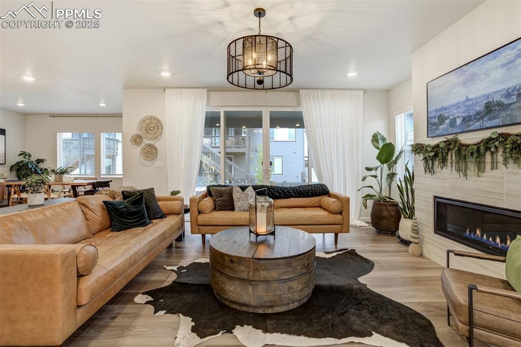 Image 2 of 50: Living area featuring plenty of natural light, light wood-style floors, a t