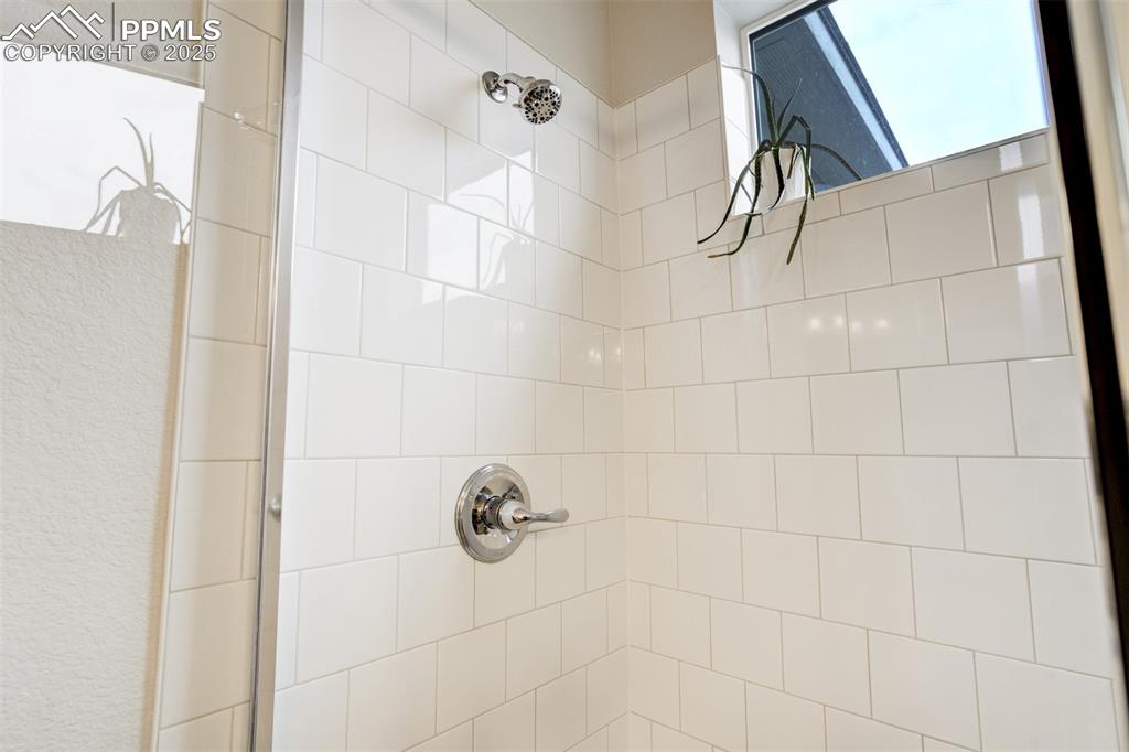 Image 24 of 50: Bathroom view of a tile shower