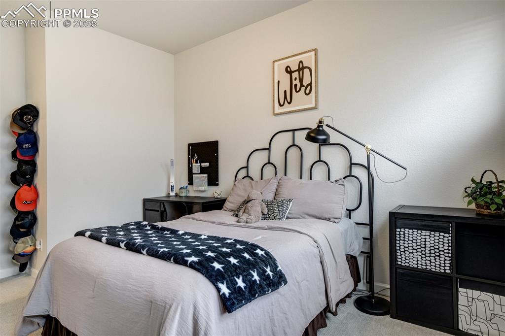 Image 29 of 50: Carpeted bedroom featuring baseboards