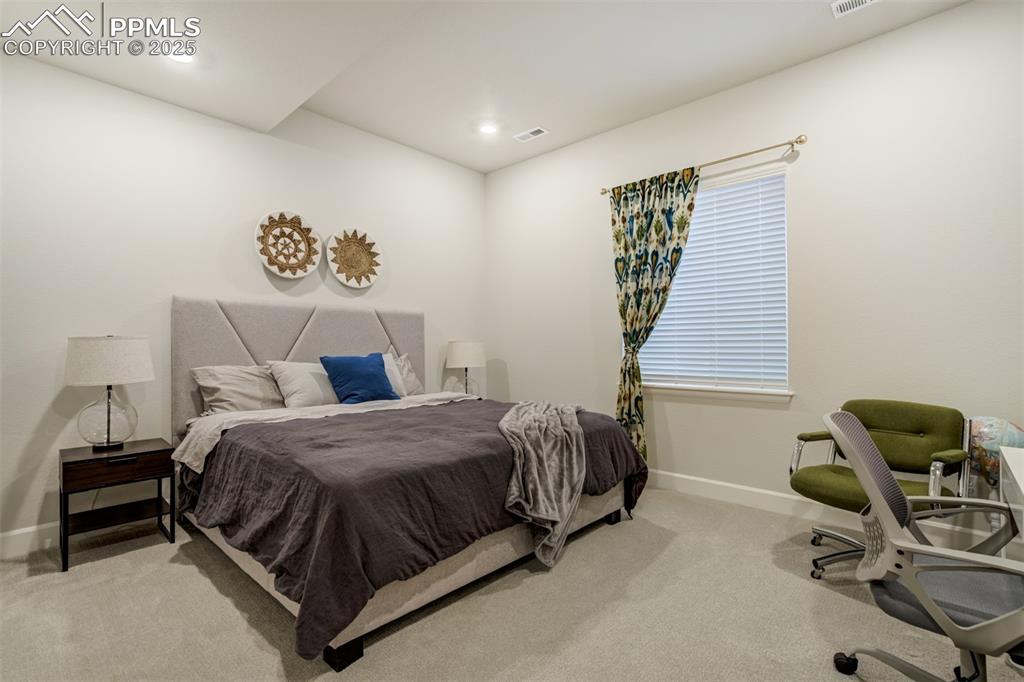 Image 37 of 50: Bedroom featuring light carpet, a desk, and recessed lighting