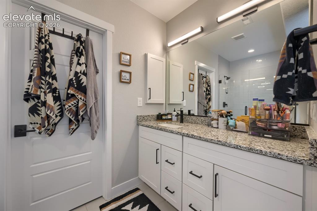 Image 30 of 38: Ensuite bathroom.  The second laundry room serves all three lower level bed