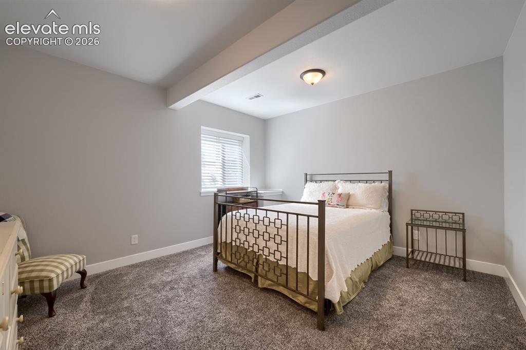 Image 33 of 38: Spacious third bedroom.  Or exercise room.  Convenient lower level laundry 
