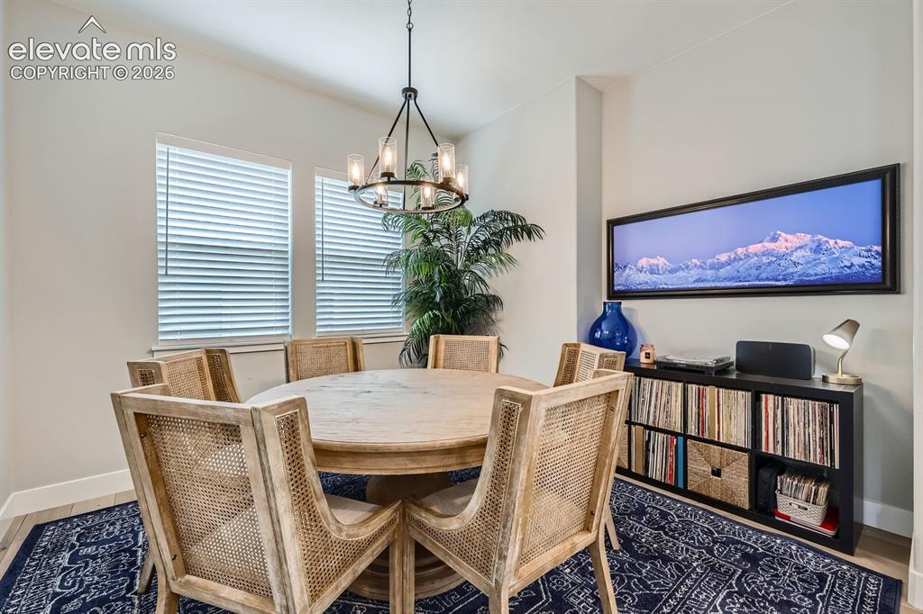 Image 7 of 38: Formal Dining Room staged with another dining set.