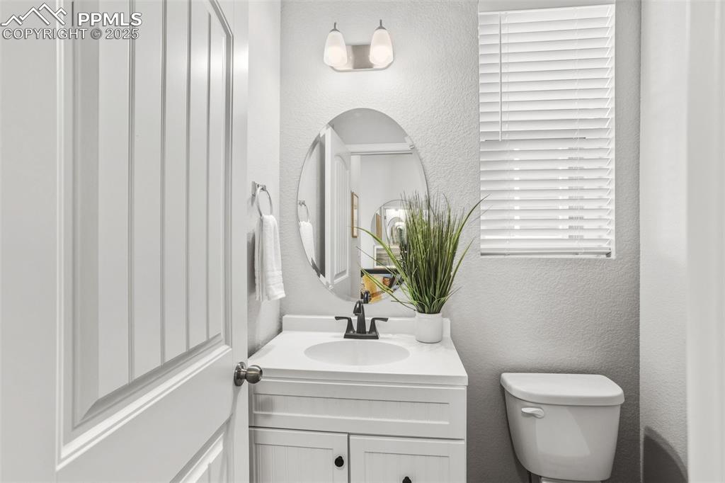 Image 14 of 37: Bathroom featuring a textured wall and vanity