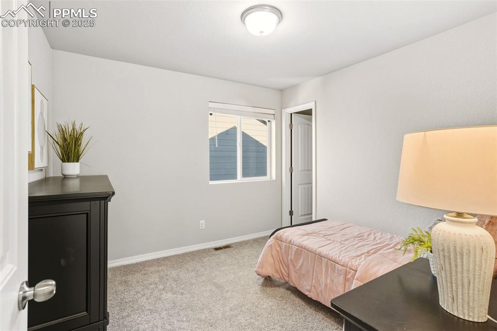 Image 22 of 37: Bedroom featuring light colored carpet and baseboards
