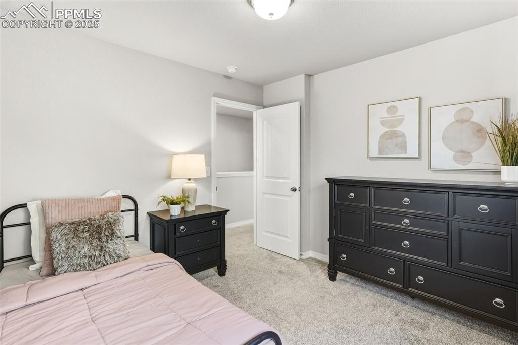 Image 23 of 37: Bedroom featuring light carpet and baseboards